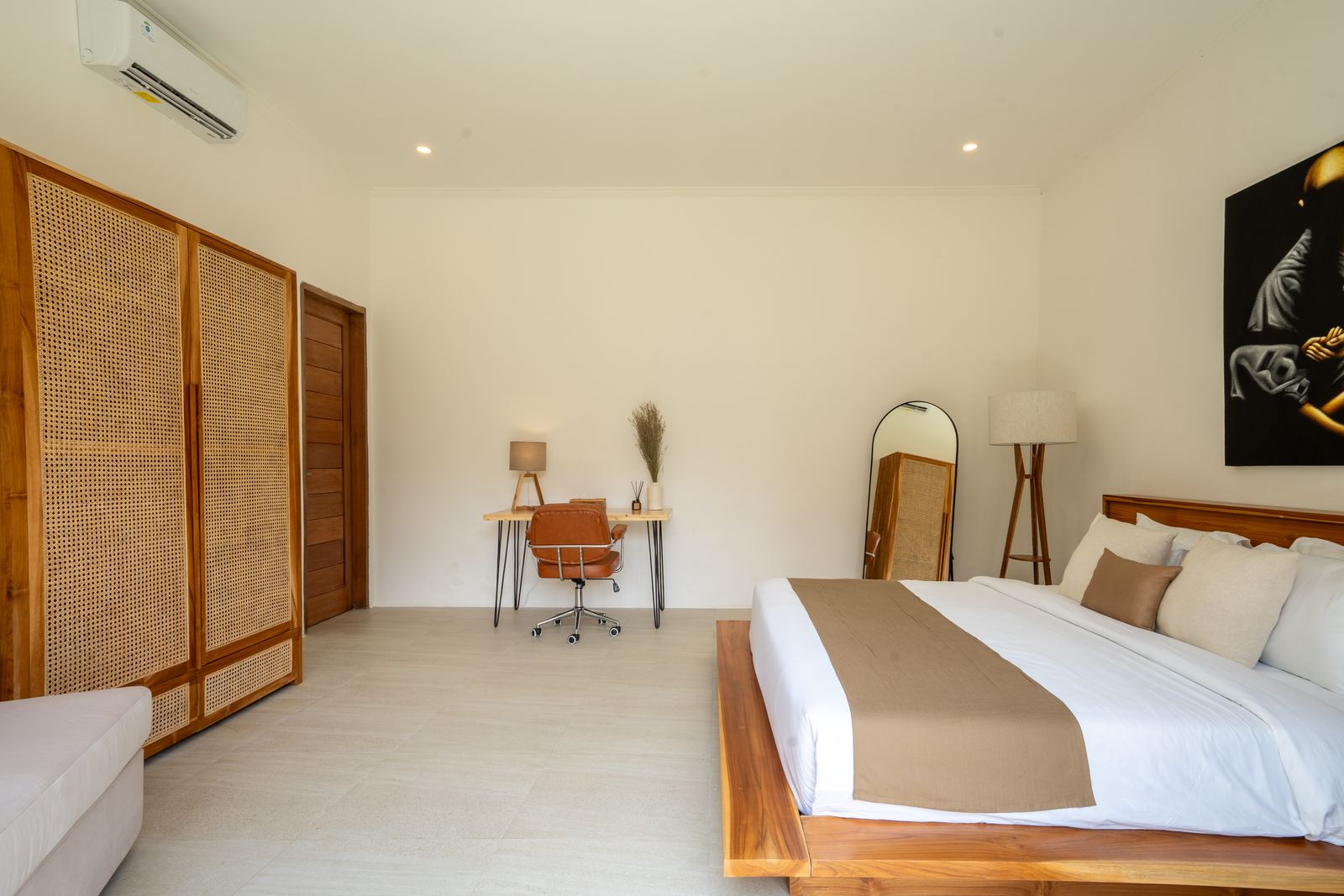 Bedroom with workspace and rattan wardrobe