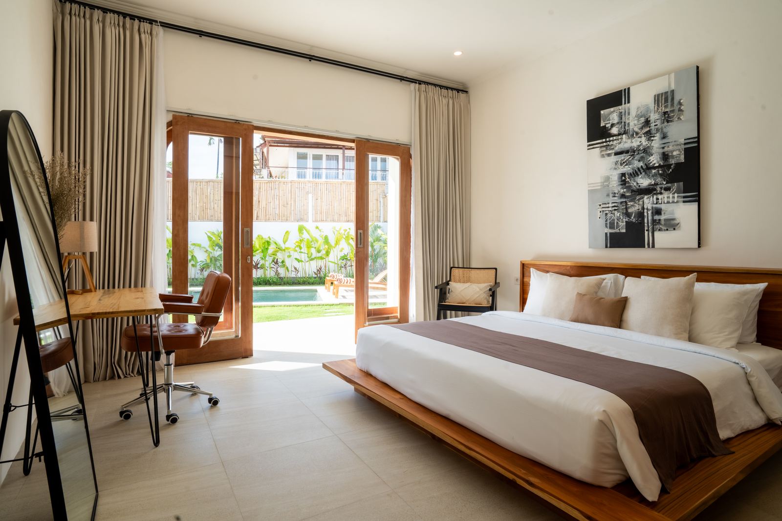 Bedroom with desk and doors to the pool